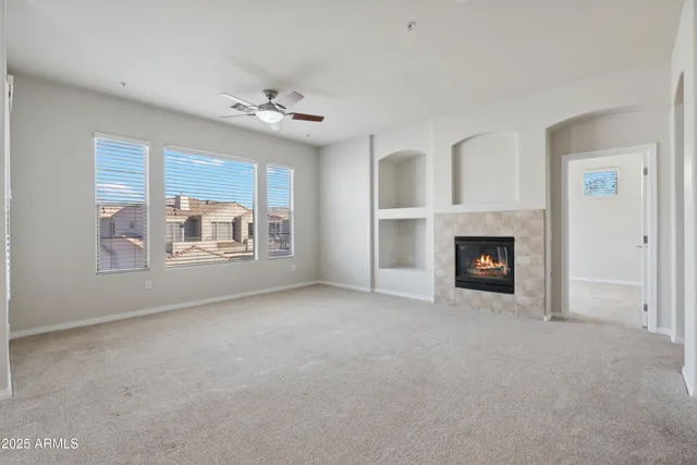 a view of a livingroom with an empty space and a fireplace