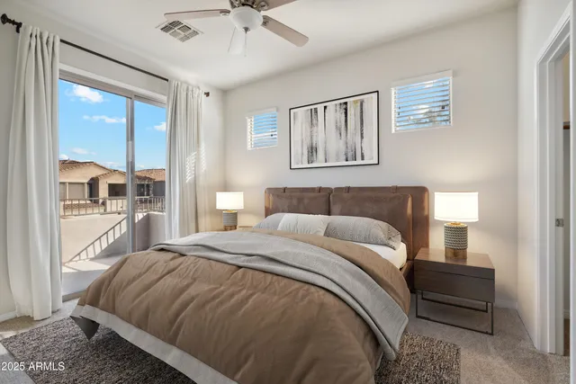 a bedroom with a large bed and a window