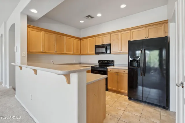 a kitchen with a refrigerator and a sink