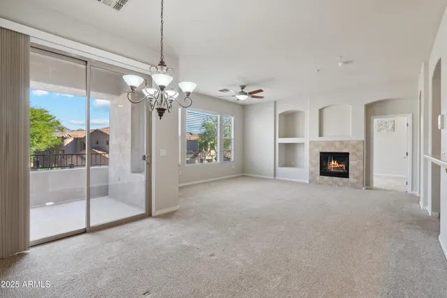 a view of a livingroom with a ceiling fan window and entryway