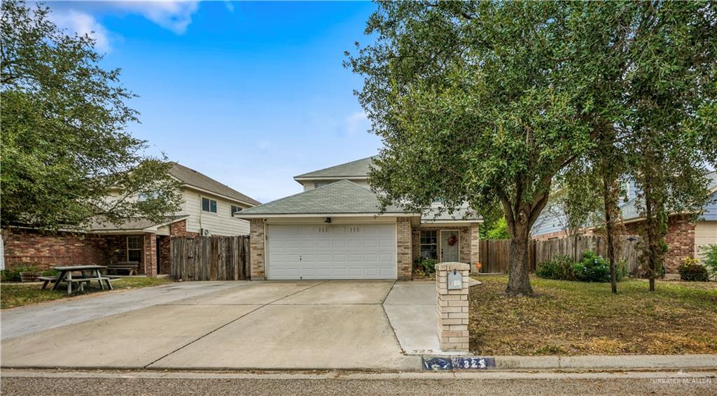 325 Roundup Circle Edinburg, TX 78539 - Photo 1 of 13 a front view of a house with a yard and garage