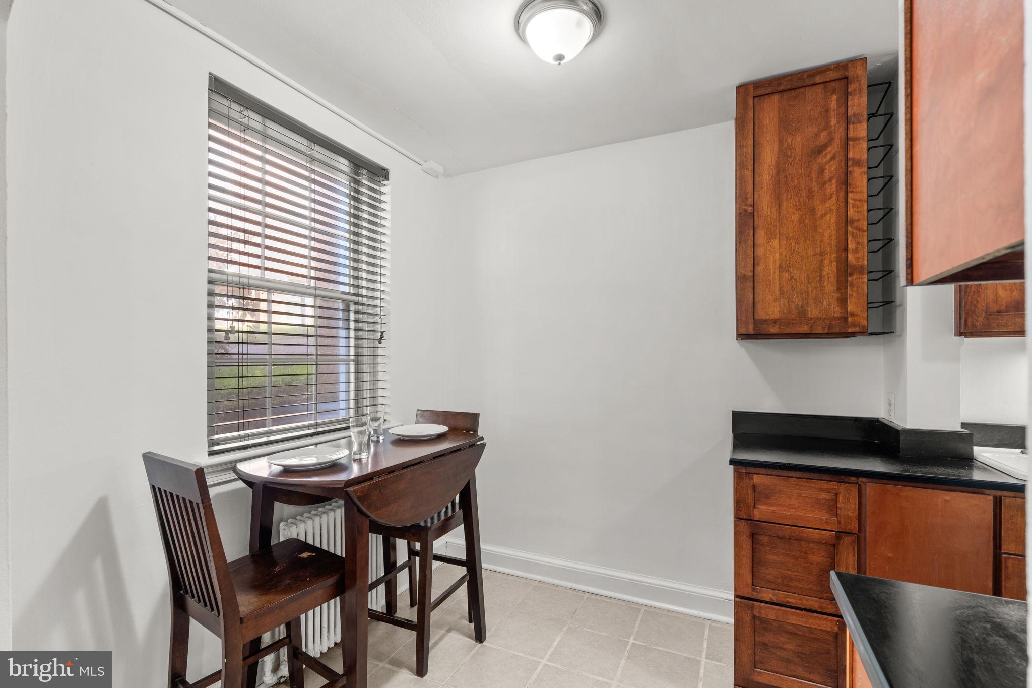 4581 MacArthur Boulevard Northwest, Unit 103 Washington, DC 20007 - Photo 14 of 28 a view of a dining room with furniture and window