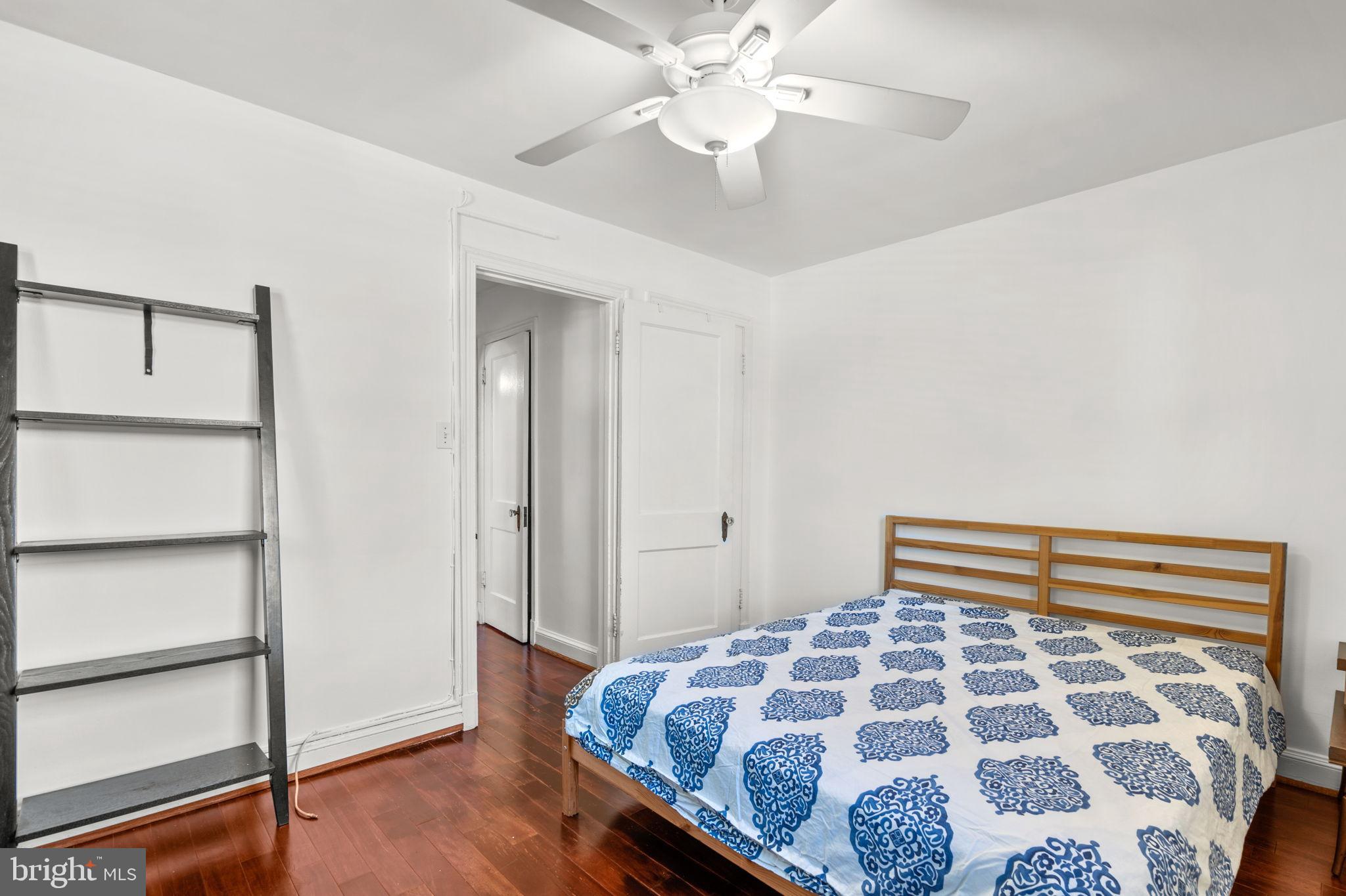 4581 MacArthur Boulevard Northwest, Unit 103 Washington, DC 20007 - Photo 19 of 28 a bedroom with a bed and a chandelier