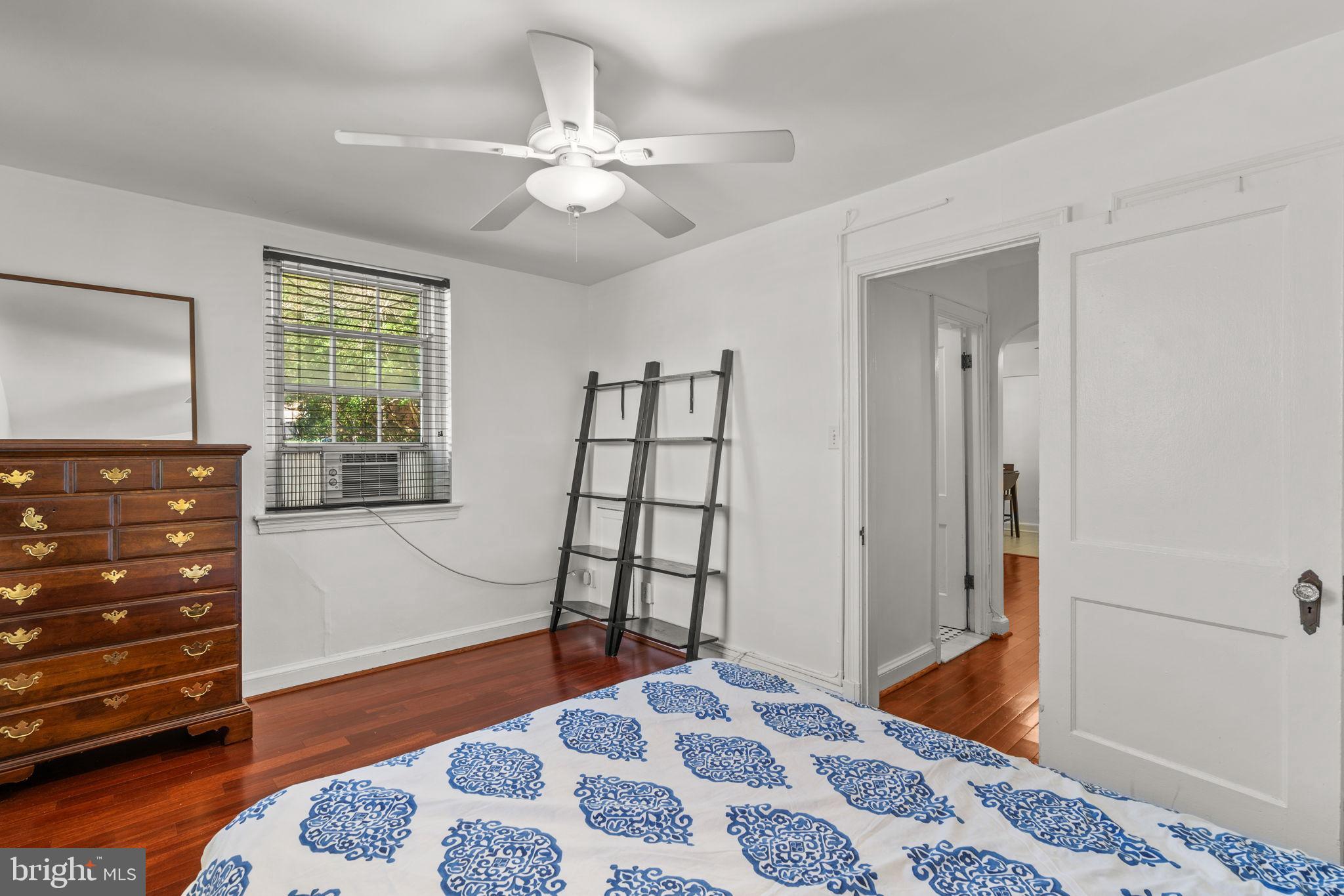 4581 MacArthur Boulevard Northwest, Unit 103 Washington, DC 20007 - Photo 20 of 28 a bedroom with a bed and wooden floor