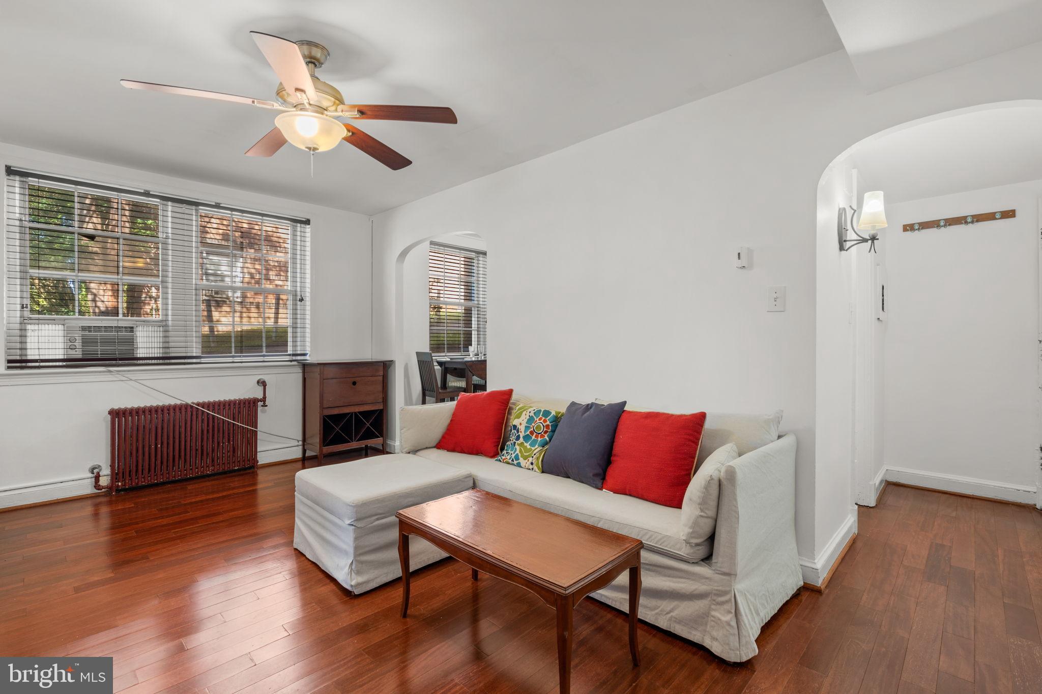 4581 MacArthur Boulevard Northwest, Unit 103 Washington, DC 20007 - Photo 2 of 28 a living room with furniture and wooden floor