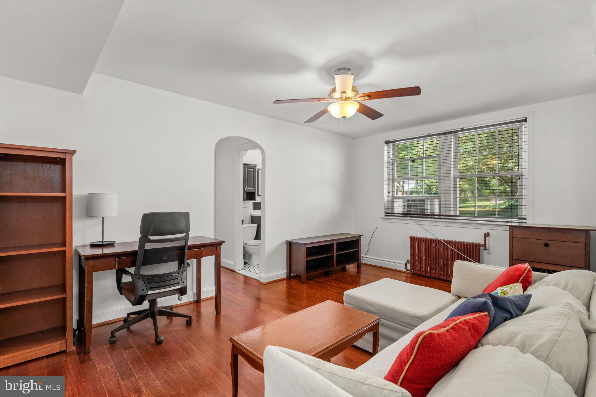 4581 MacArthur Boulevard Northwest, Unit 103 Washington, DC 20007 - Photo 3 of 28 a living room with furniture and a window