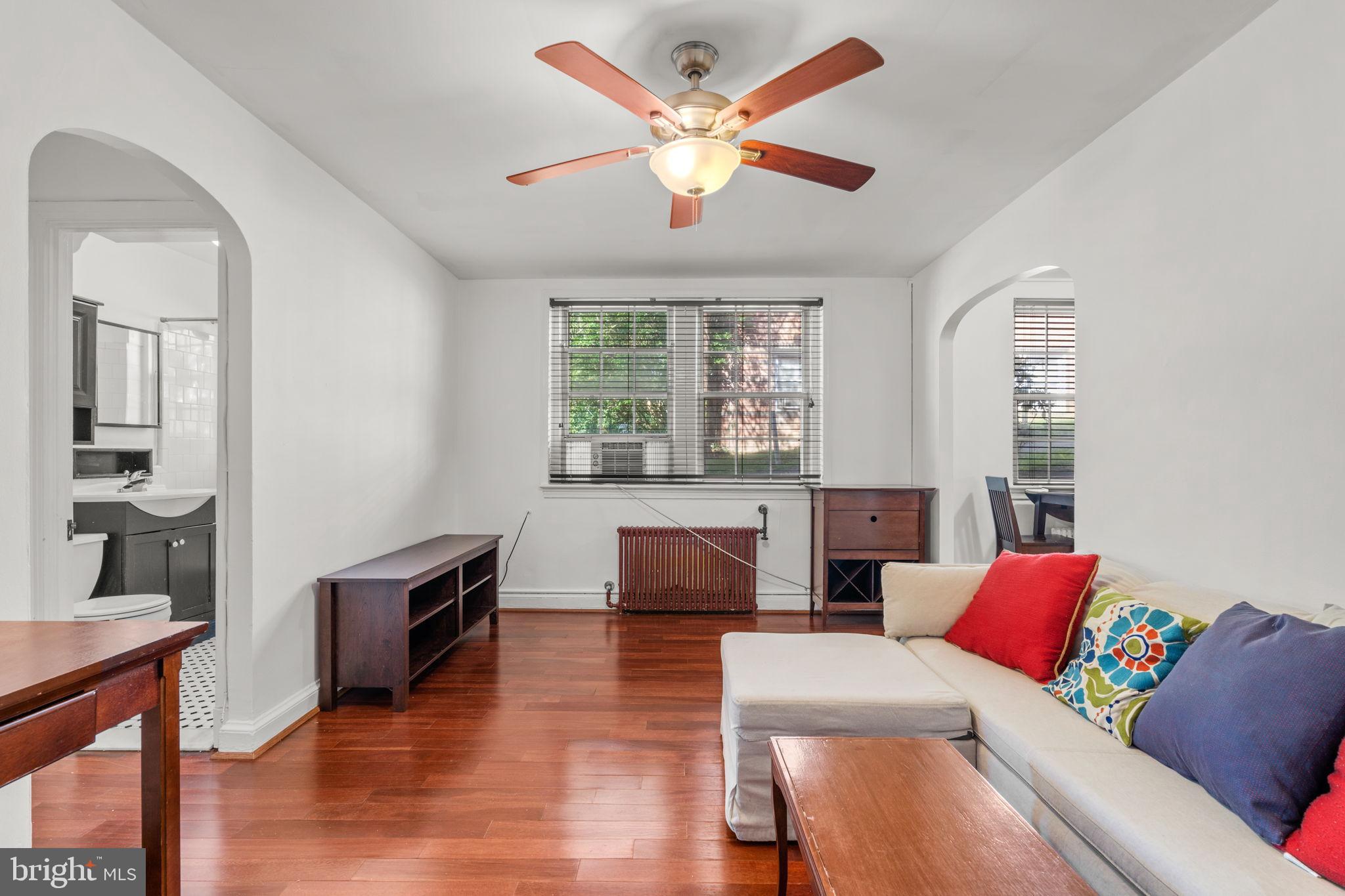 4581 MacArthur Boulevard Northwest, Unit 103 Washington, DC 20007 - Photo 4 of 28 a living room with furniture and a large window