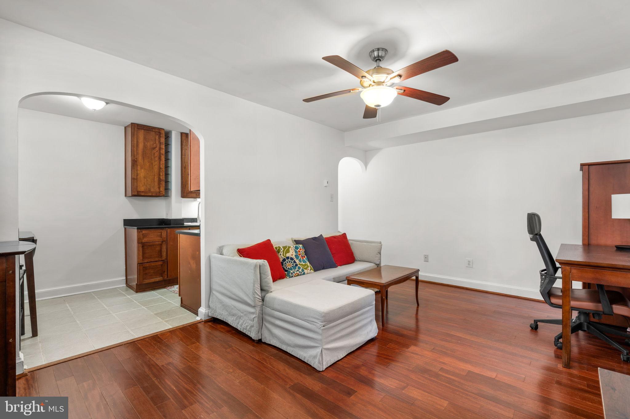 4581 MacArthur Boulevard Northwest, Unit 103 Washington, DC 20007 - Photo 5 of 28 a living room with furniture and wooden floor