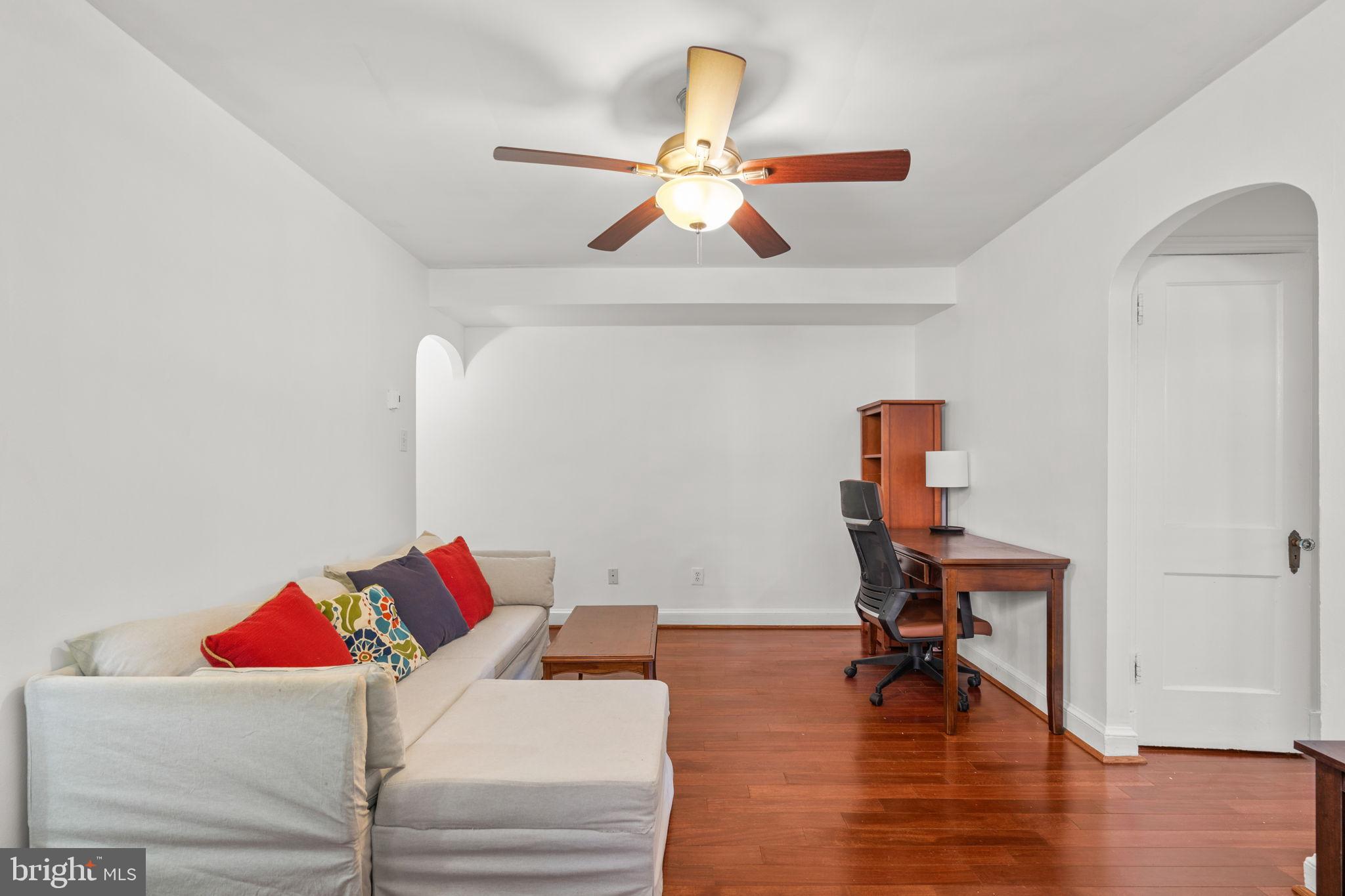 4581 MacArthur Boulevard Northwest, Unit 103 Washington, DC 20007 - Photo 6 of 28 a living room with furniture and a wooden floor