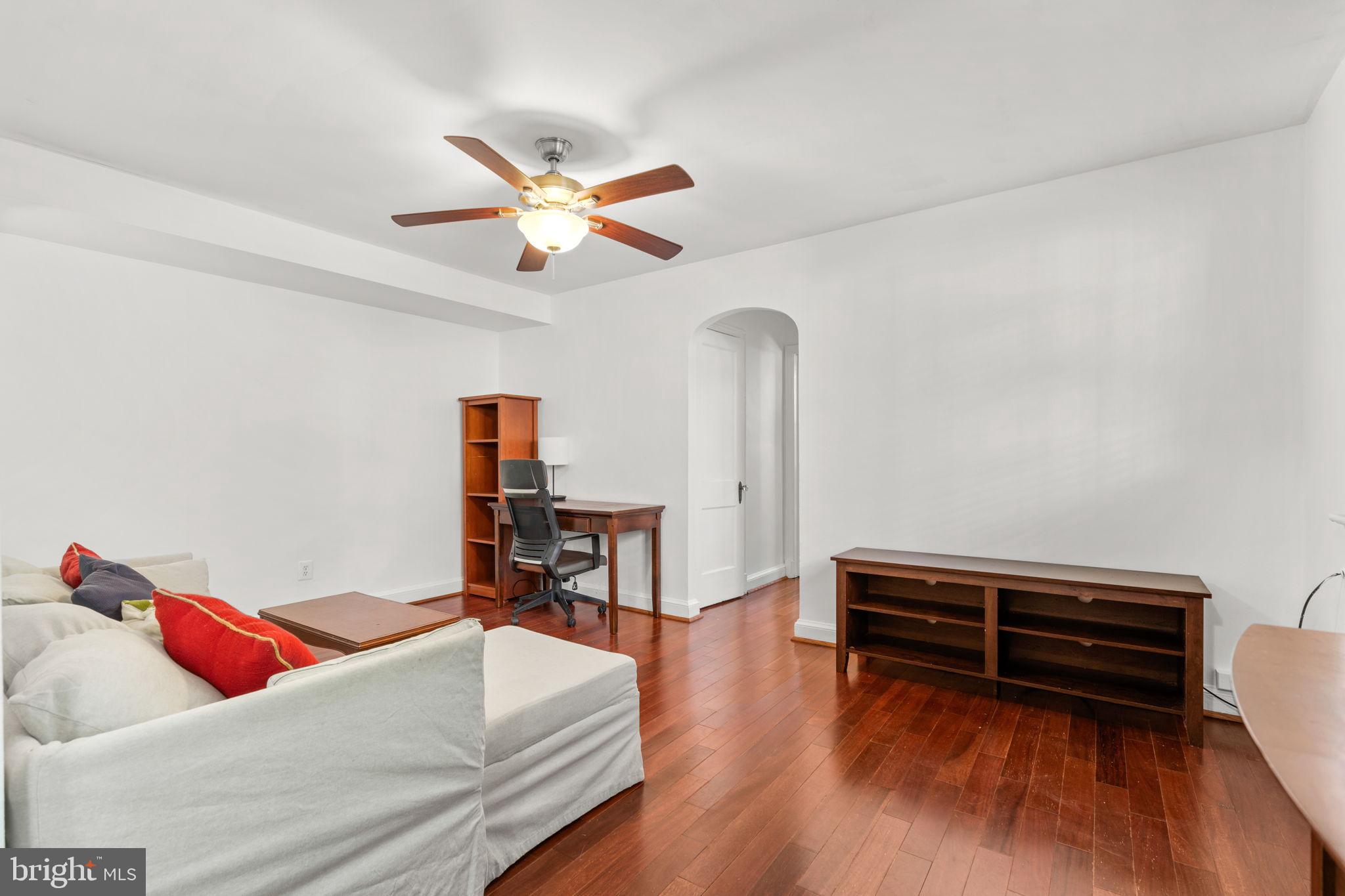 4581 MacArthur Boulevard Northwest, Unit 103 Washington, DC 20007 - Photo 7 of 28 a living room with furniture and a wooden floor