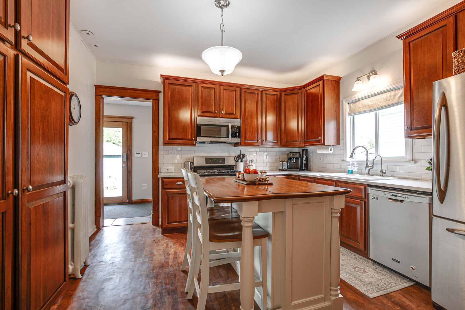 120 Atteridge Road Lake Forest, IL 60045 - Photo 10 of 26 a kitchen with stainless steel appliances granite countertop a stove top oven a refrigerator a sink and dishwasher with wooden floor