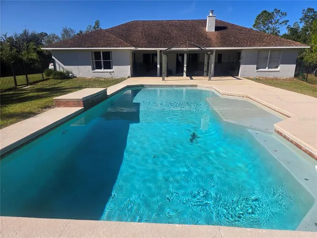 a bedroom with a bed and a flat tv screen on the dresser