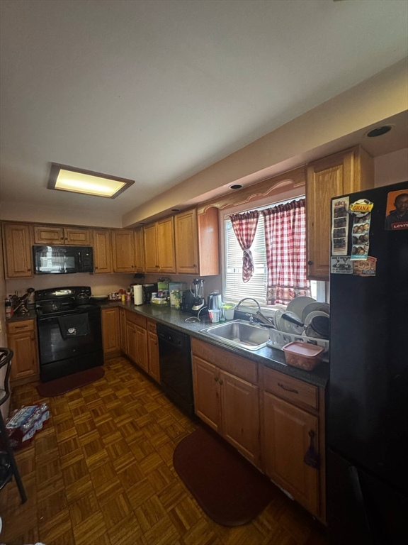 87 Exeter Street Lowell, MA 01850 - Photo 2 of 11 a kitchen with stainless steel appliances granite countertop a sink stove and refrigerator