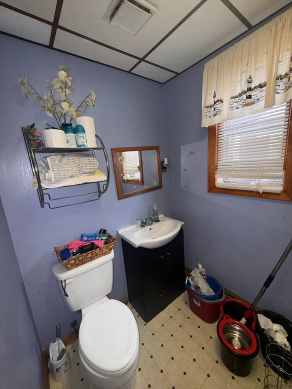 87 Exeter Street Lowell, MA 01850 - Photo 8 of 11 a bathroom with a sink a toilet and a mirror