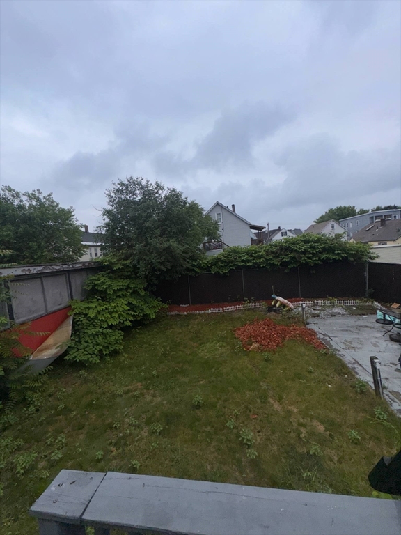87 Exeter Street Lowell, MA 01850 - Photo 9 of 11 a backyard of a house with lots of green space