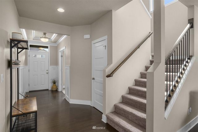 a view of entryway with stairs and wooden floor