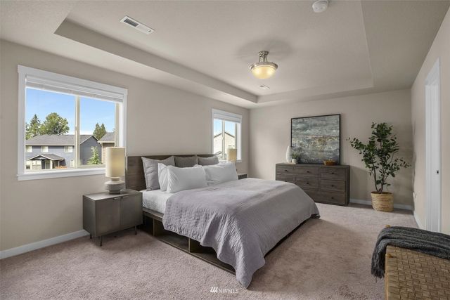 a bedroom with a bed potted plant with the window