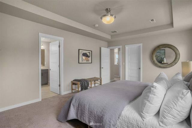 a bedroom with a bed and a chandelier