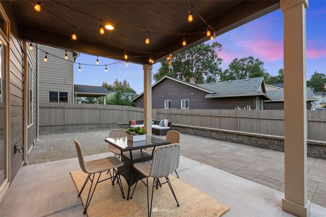 a view of a house with a yard and sitting area
