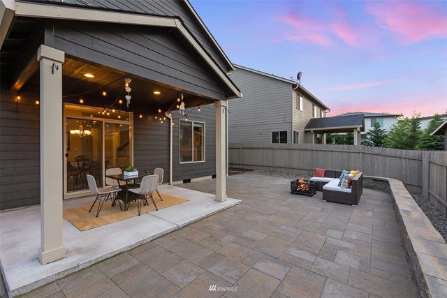 a view of a patio with table and chairs potted plants with wooden fence
