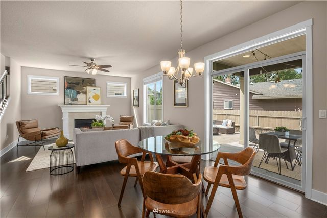 a dining room with furniture a window and wooden floor