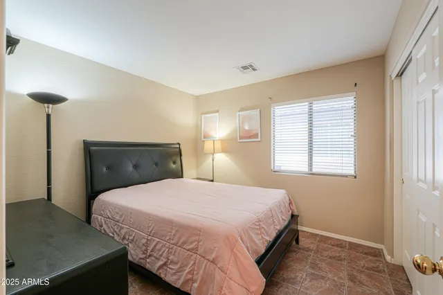 a bedroom with a bed and a night stand