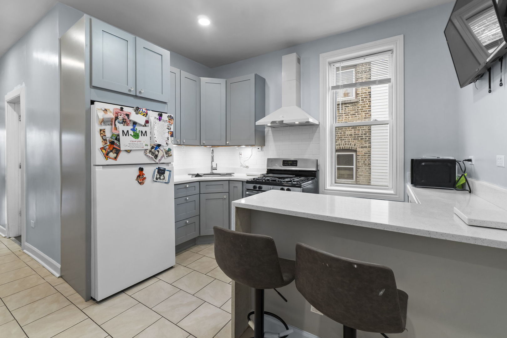 4920 West Iowa Street Chicago, IL 60651 - Photo 14 of 33 a kitchen with stainless steel appliances a refrigerator and a stove top oven