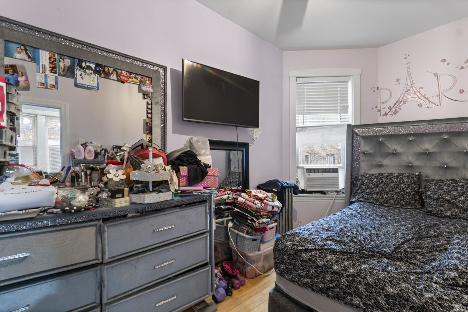 4920 West Iowa Street Chicago, IL 60651 - Photo 20 of 33 a bed room with a bed a flat screen tv and a window