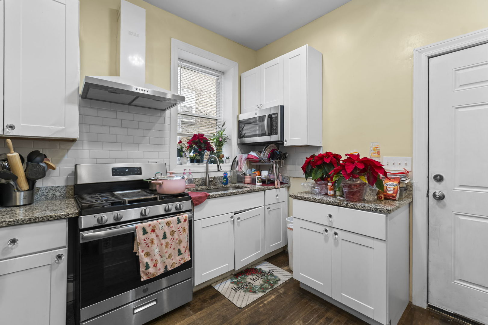 4920 West Iowa Street Chicago, IL 60651 - Photo 24 of 33 a kitchen with white cabinets and appliances