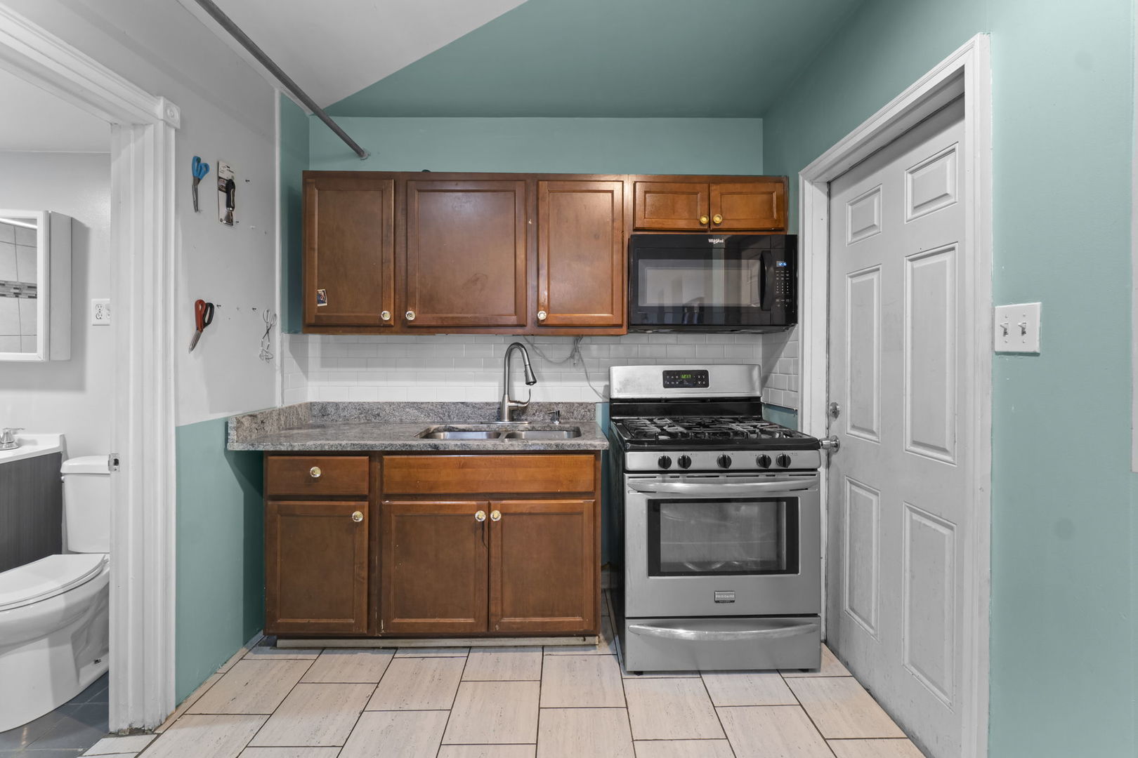4920 West Iowa Street Chicago, IL 60651 - Photo 28 of 33 a kitchen with stainless steel appliances granite countertop a stove a sink and a microwave