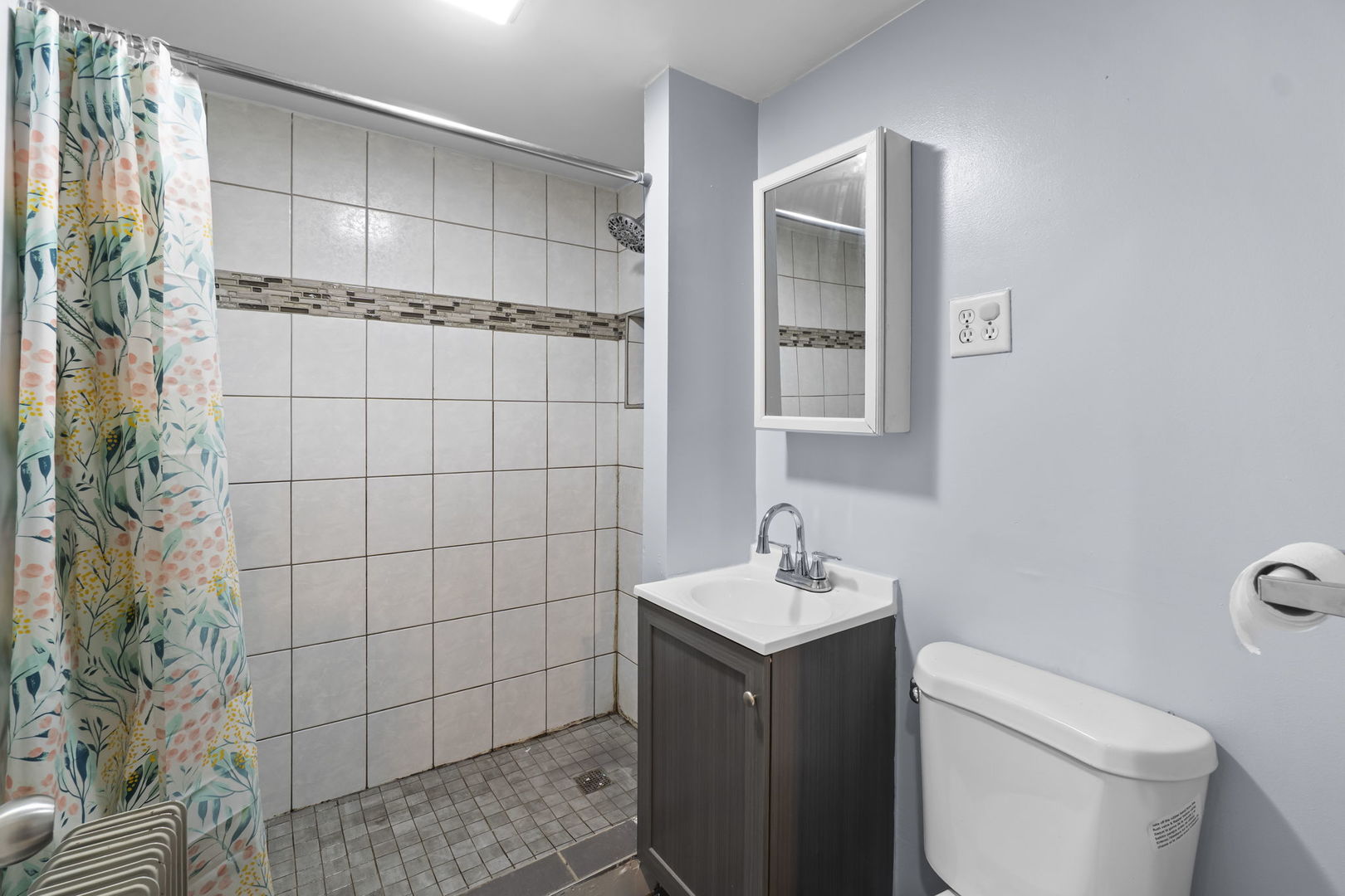 4920 West Iowa Street Chicago, IL 60651 - Photo 33 of 33 a bathroom with a sink a toilet and shower