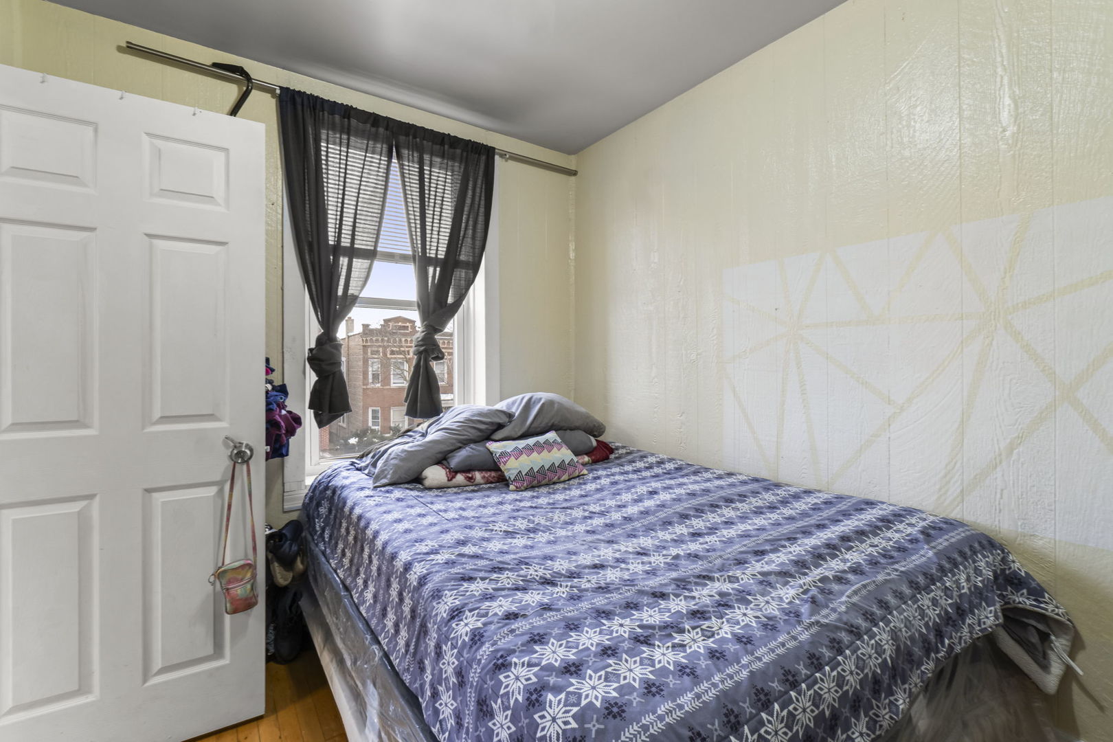4920 West Iowa Street Chicago, IL 60651 - Photo 5 of 33 a bedroom with a bed window and a wooden floor