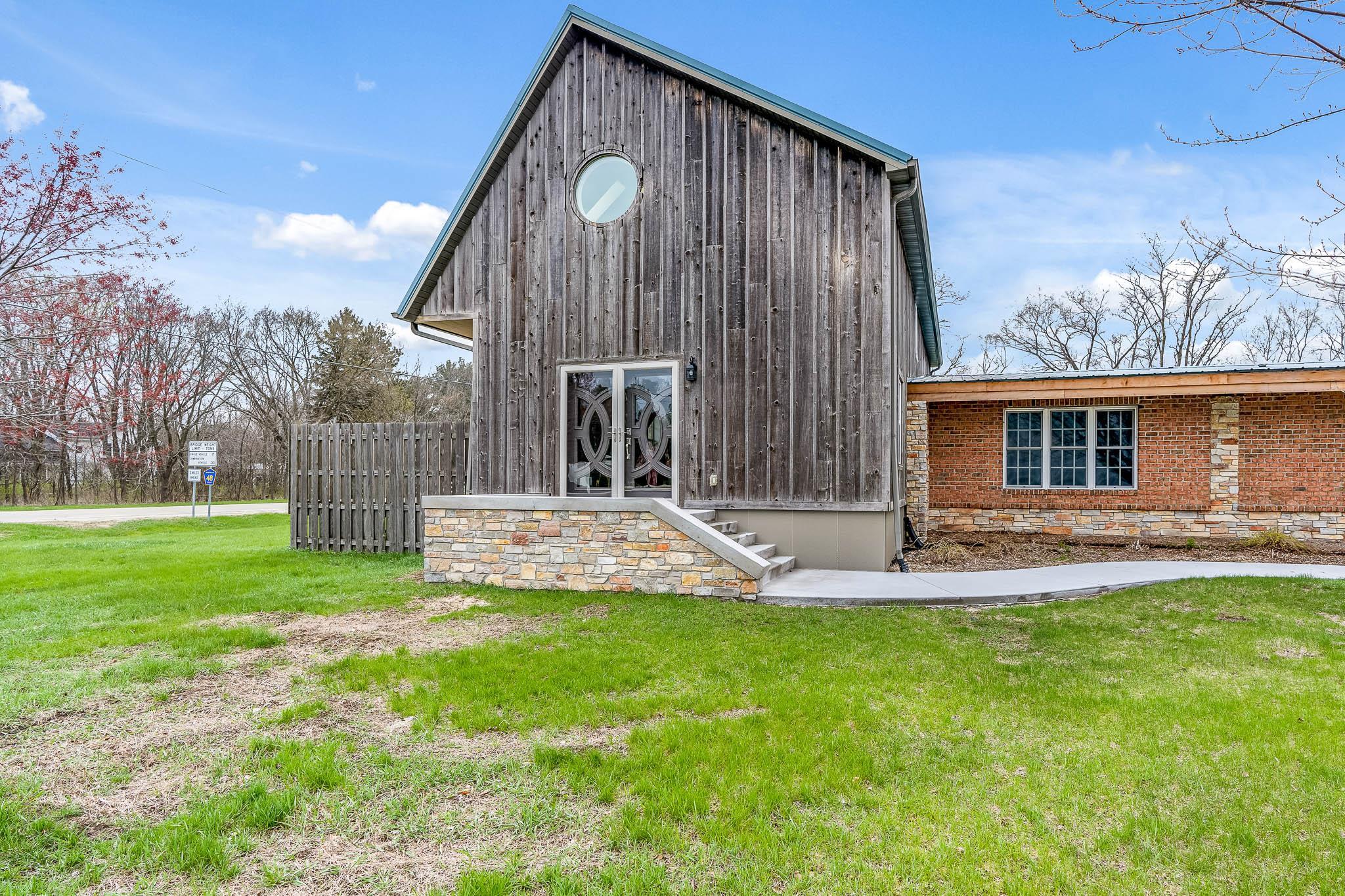 15026 Prairie Road South Beloit, IL 61080 - Photo 54 of 64 a front view of a house with a yard table and chairs