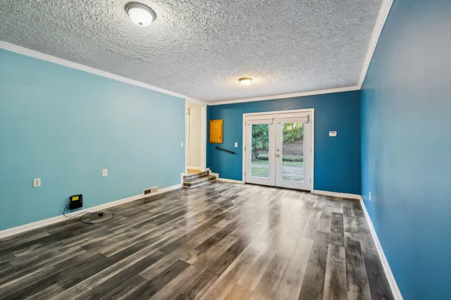 a view of a room with wooden floor and window