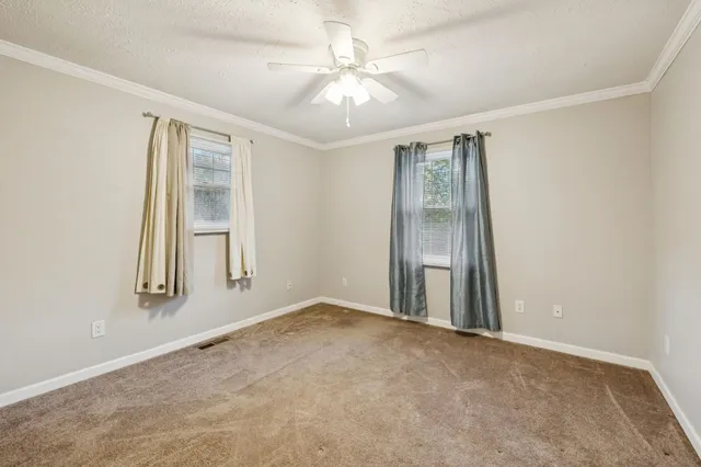 an empty room with windows and closet