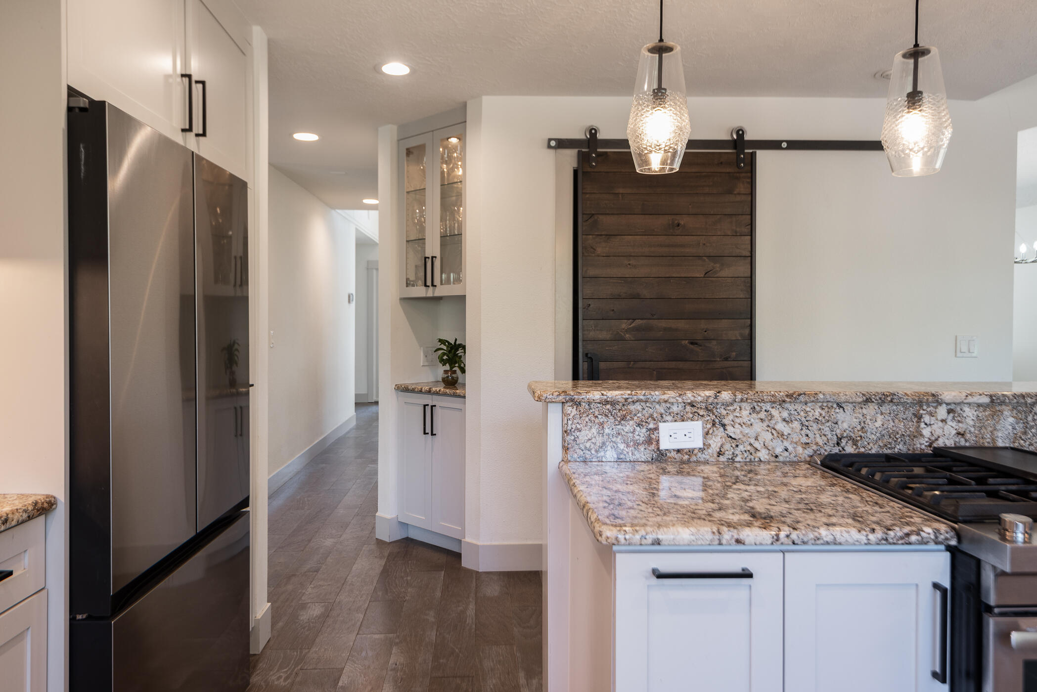 60012 West Ridgeview Drive Bend, OR 97702 - Photo 8 of 55 a bathroom with a granite countertop sink a refrigerator and a mirror