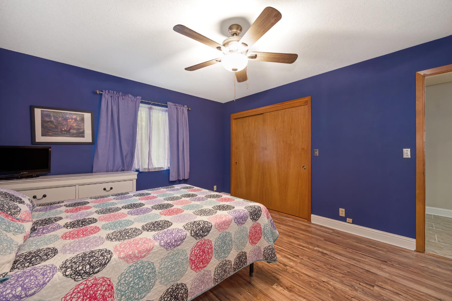 4580 Jenkinson Circle Pollock Pines, CA 95726 - Photo 19 of 78 a bedroom with a large bed and a chandelier