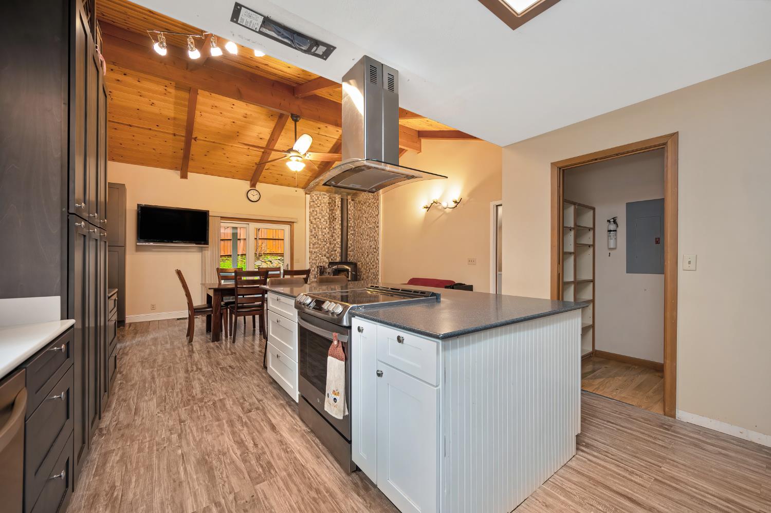 4580 Jenkinson Circle Pollock Pines, CA 95726 - Photo 30 of 78 a kitchen with stainless steel appliances a stove a sink dishwasher and a refrigerator with wooden floor