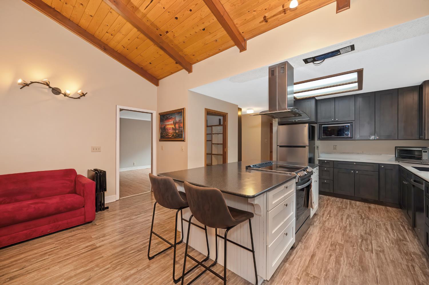 4580 Jenkinson Circle Pollock Pines, CA 95726 - Photo 31 of 78 a kitchen with stainless steel appliances granite countertop a refrigerator a stove and a wooden floors