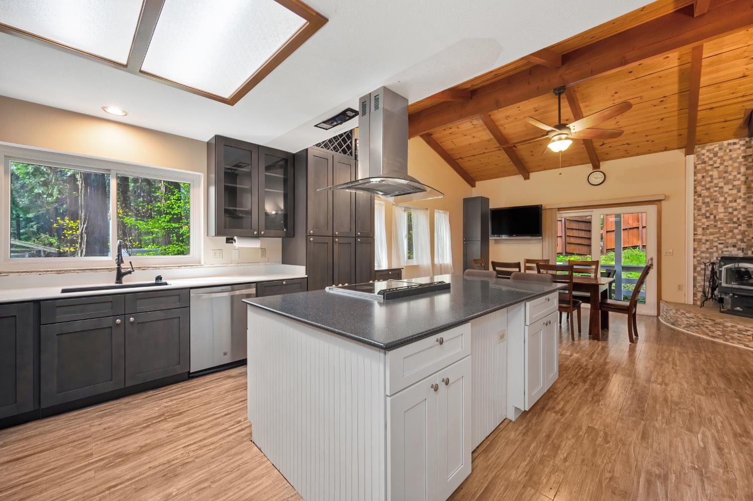 4580 Jenkinson Circle Pollock Pines, CA 95726 - Photo 38 of 78 a kitchen with stainless steel appliances granite countertop a sink and wooden floors