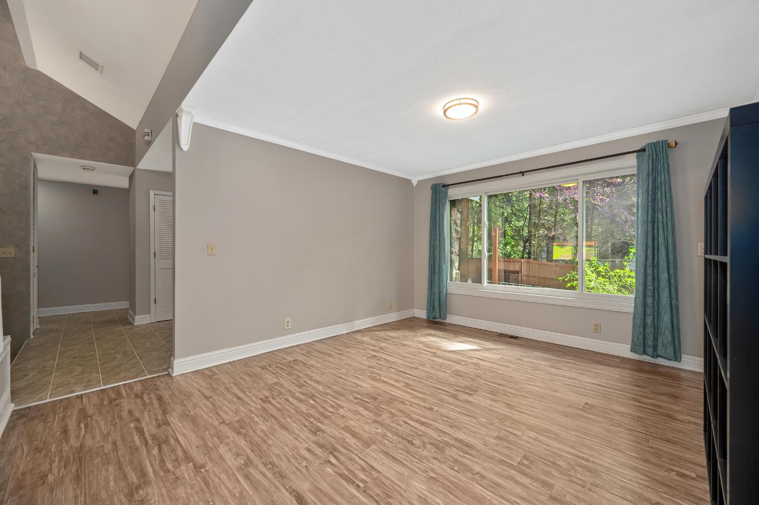 4580 Jenkinson Circle Pollock Pines, CA 95726 - Photo 42 of 78 a view of an empty room with wooden floor and a window