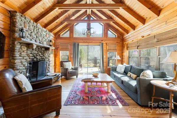 a living room with furniture fireplace and a large window