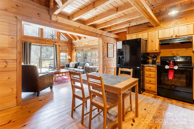 a view of a dining room with furniture a chandelier and wooden floor