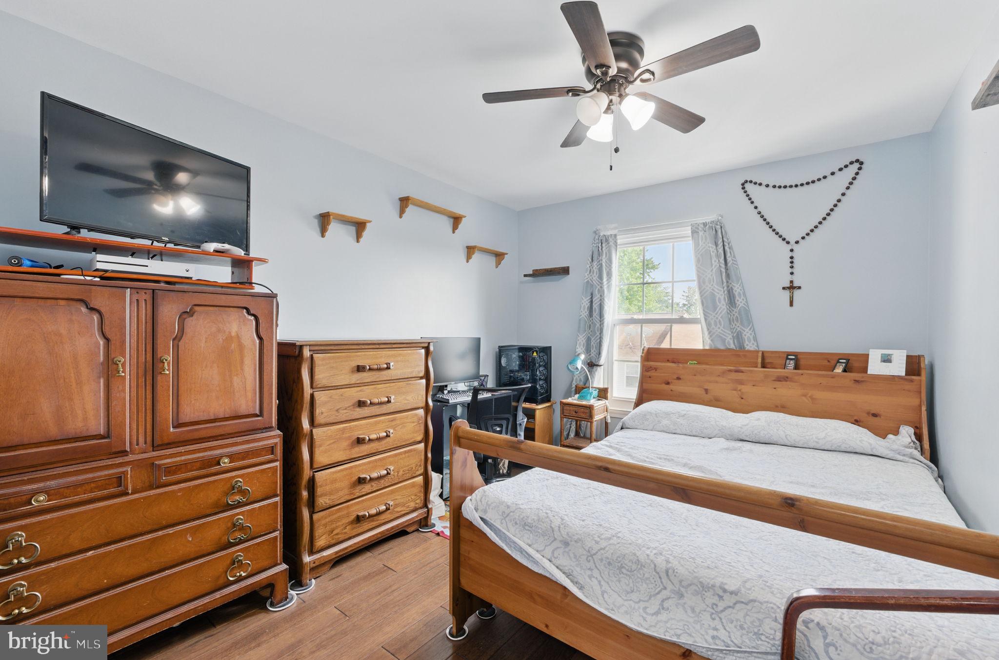 6837 Cottingham Lane Centreville, VA 20121 - Photo 17 of 25 a bedroom with a bed and a chandelier