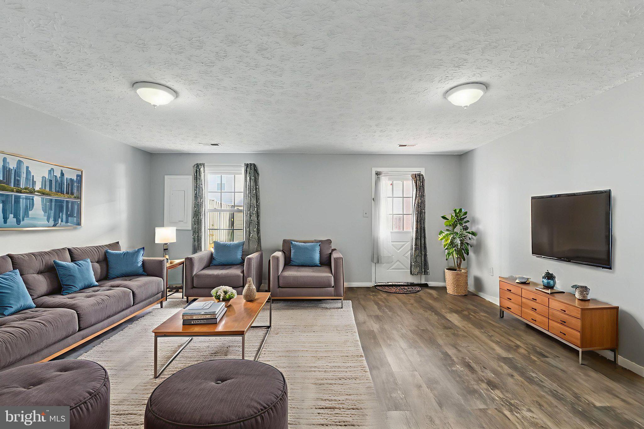 6837 Cottingham Lane Centreville, VA 20121 - Photo 19 of 25 a living room with furniture and a flat screen tv