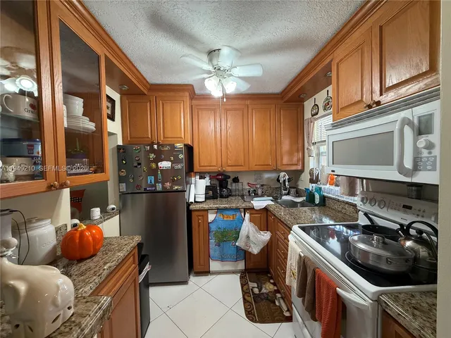 a kitchen with a sink appliances and cabinets