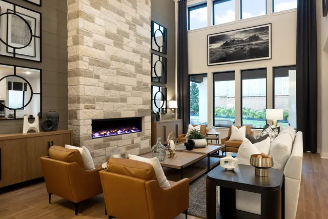 a living room with furniture a fireplace and windows
