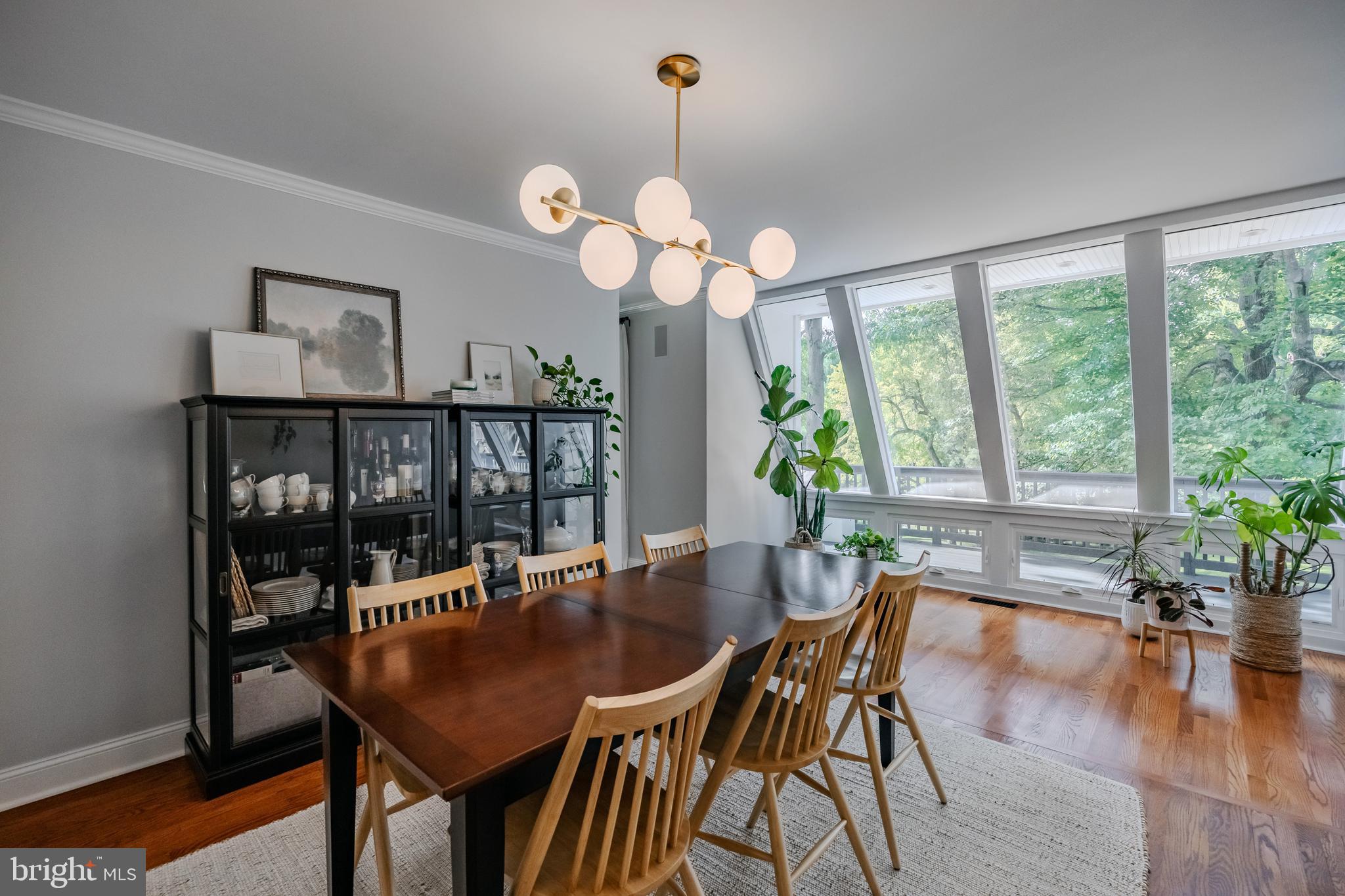 65 Roberts Road Newtown Square, PA 19073 - Photo 11 of 53 a dining room with wooden floor a chandelier a wooden table and chairs