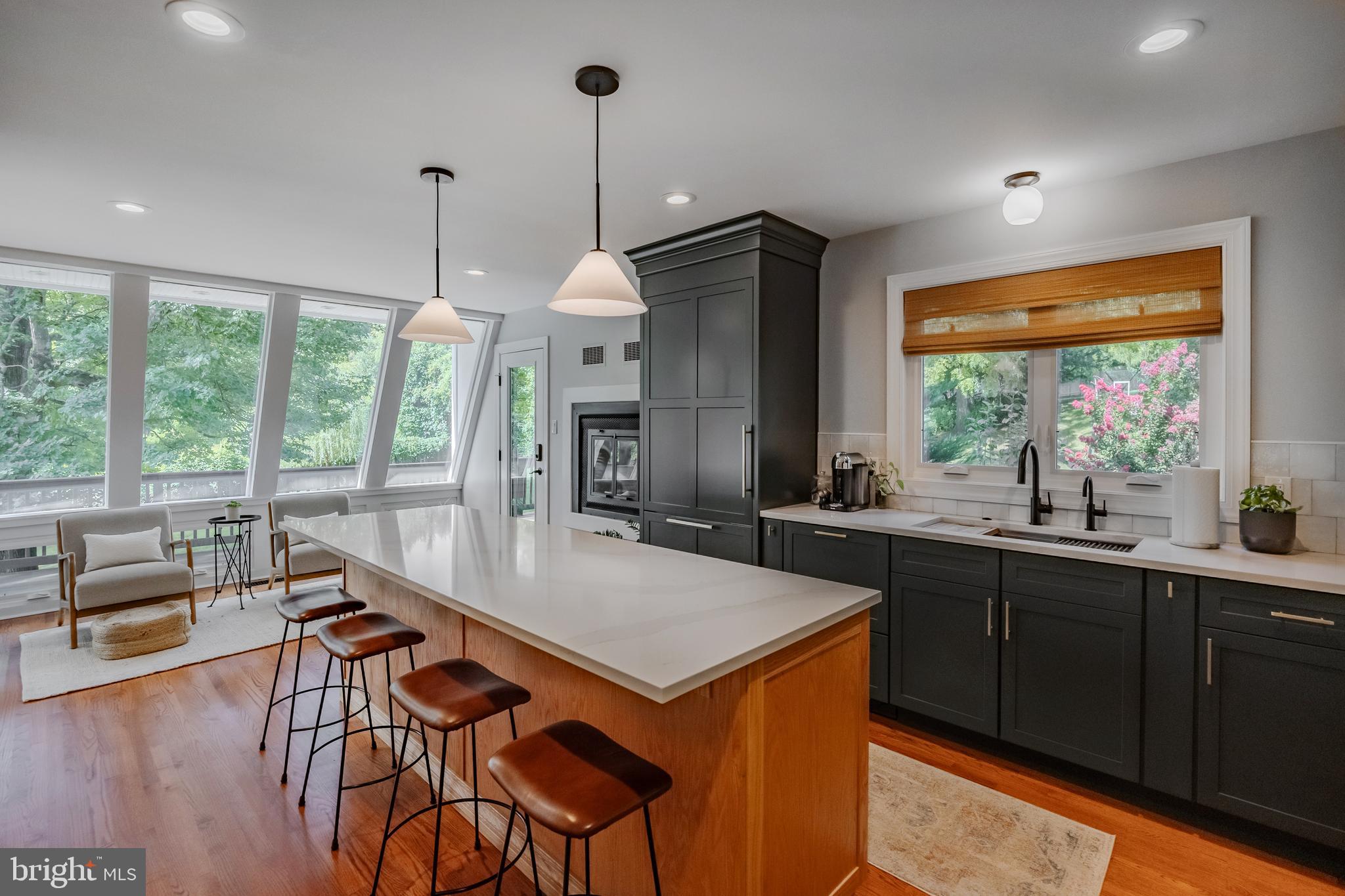 65 Roberts Road Newtown Square, PA 19073 - Photo 19 of 53 a open kitchen with stainless steel appliances granite countertop wooden cabinets a stove a sink a dining table and chairs with wooden floor