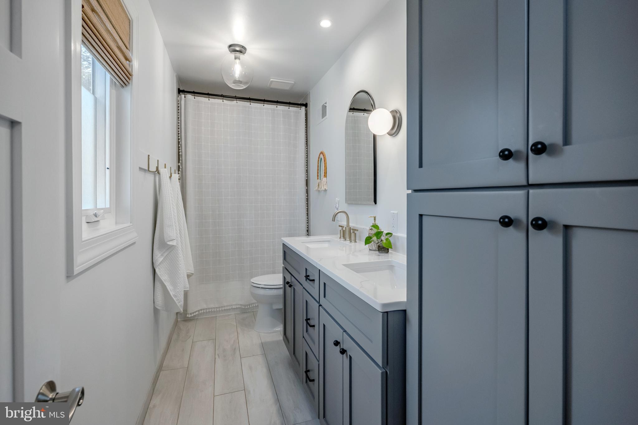 65 Roberts Road Newtown Square, PA 19073 - Photo 39 of 53 a spacious bathroom with a double vanity sink and a mirror
